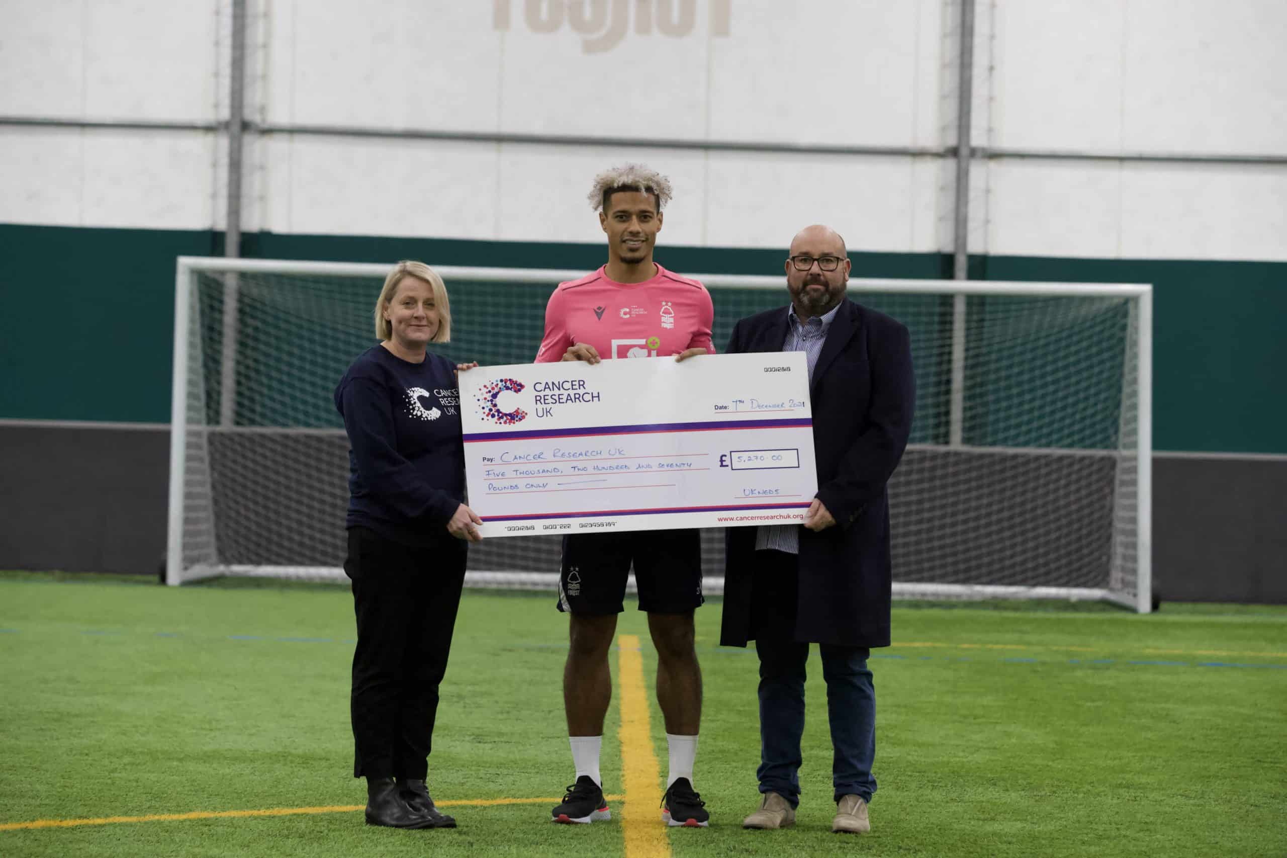 UK Meds present cheque to Nottingham Forest footballer